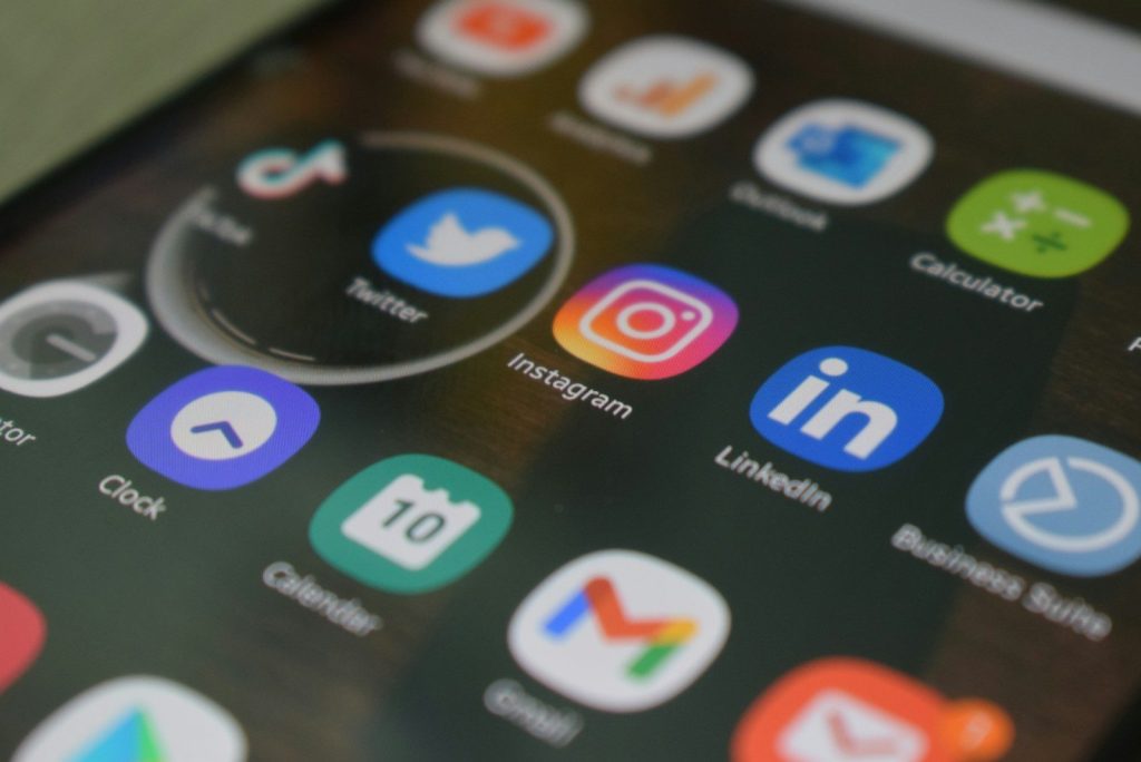 Home A close up of a cell phone with various social icons